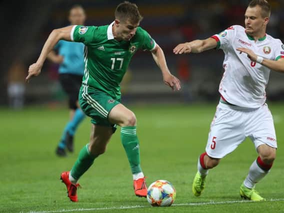 Belarus' Denis Polyakov with Northern Ireland's Paddy McNair