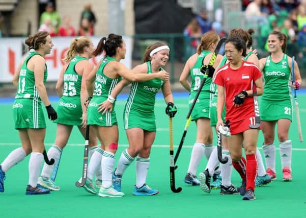 Ireland's Anna O'Flanagan celebrates scoring a goal against Singapore with team mates