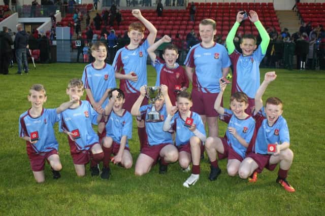 The St. Johns Primary School team celebrate after lifting the Club Derry Cup at the doire GAA mBunscol finals at Owenbeg on Friday.