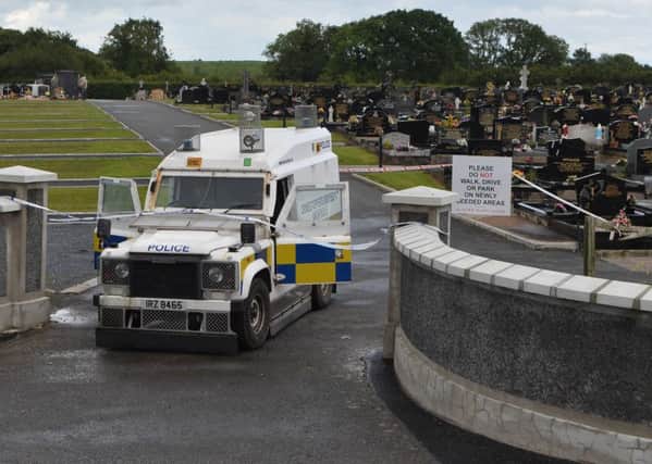 Police at the scene of a security alert at a  Lurgan cemetery on Monday. I
t is understood the Army bomb disposal team has been called to St Coleman's graveyard in Lurgan, Co Armagh.
Photo: Colm Lenaghan/Pacemaker