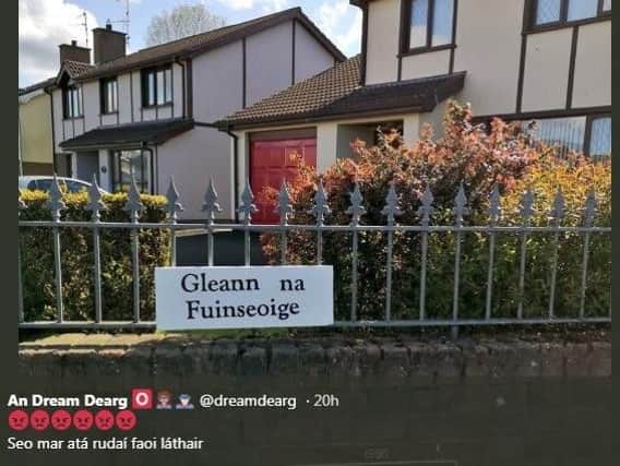 An Dream Dearg's tweet shows the sign that has been erected on the fence of a house at Ashdale, Randalstown.