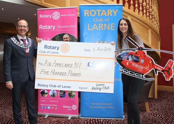 Michael Thompson, President of Rotary Club of Larne, presented a cheque for £500 to Grace Williamsn of Air Ambulance Northern Ireland.