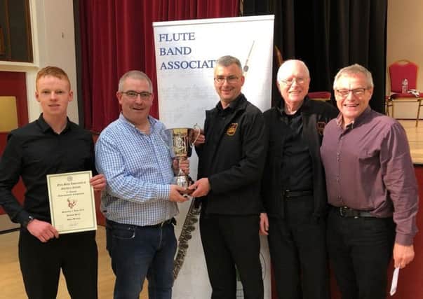 Gregory Lutton, Kellswater Band, receives the Best Grade 2 Band award from Stephen Bailie at the recent Flute Band Association Contest.