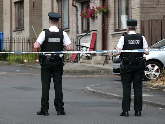 Police at the scene of the murder investigation at Coulson Avenue, Lisburn.  Photo: Press Eye