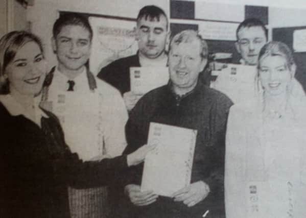 Suzanne Devlin of Abbey Training Services presents NVQ Level Two certificates in retailing and wholesale to Matt Davis, Julian Smyth, Alan Ritchie, Tony Madden, Fiona Campbell and Andrea McCormick. 1997