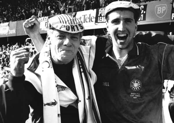 The late George Richardson (left), a long-serving Portadown kitman, celebrating trophy success with Philip Major in 1991.