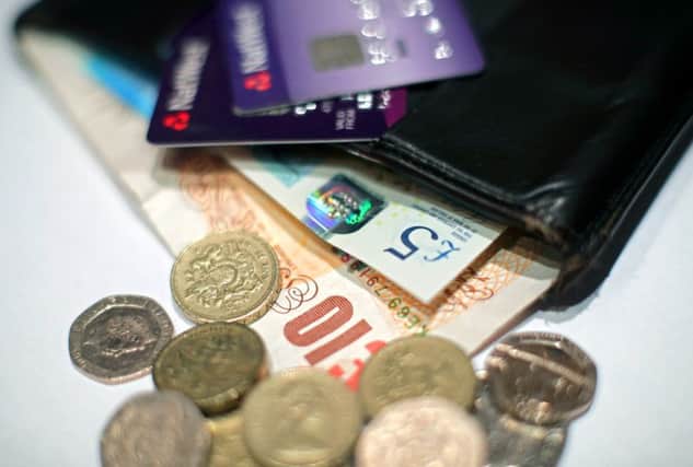 File photo dated 29/01/17 of money and bank cards in a wallet, as the UK tax burden is set to rise to its highest level for 30 years under Chancellor Philip Hammond's plans, despite continuing cuts in public services, according to an influential economic think tank. PRESS ASSOCIATION Photo. Issue date: Tuesday February 7, 2017. And the austerity regime of tax rises and spending cuts is set to continue well into the 2020s, thanks to Mr Hammond's decision in the wake of the Brexit vote to scrap George Osborne's target of balancing the nation's books by 2019, said the Institute for Fiscal Studies. See PA story POLITICS IFS. Photo credit should read: Yui Mok/PA Wire