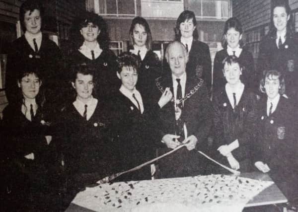 Ballymena Mayor Sandy Spence cuts the ribbon on the mini company formed at Cambridge House Girls' School. The Decorum Co. was thought up by 24 lower sixth pupils. 1989