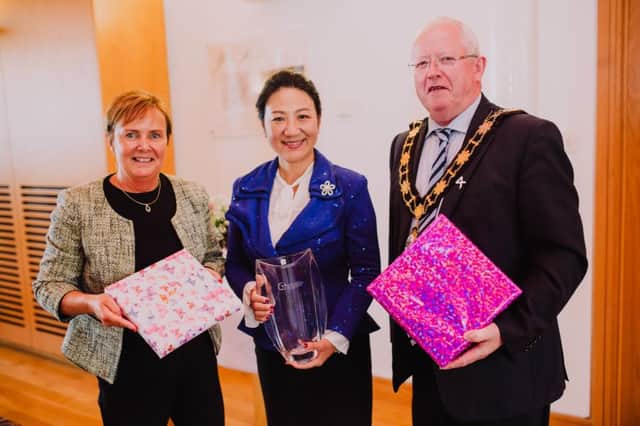 Mayor of Antrim and Newtownabbey, Alderman John Smyth is joined by Chief Executive of Antrim and Newtownabbey, Jacqui Dixon to present gifts to Chinese Consul General, Madam Zhang in Mossley Mill.