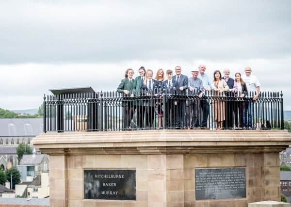 Pupils and principals of Lisneal College and St Cecilias College with the project team at the top of the monument