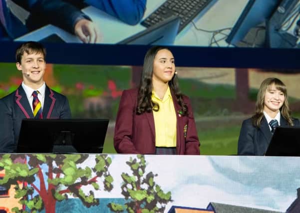 Pictured presenting their cross-community project on the main stage at the Esri International User Conference in San Diego are (L-R): Leon Van Der Westhuizen, Lurgan Junior High School; Aiesha Mouhsine, St. Ronan's College; and Hannah Trew, Lurgan College.