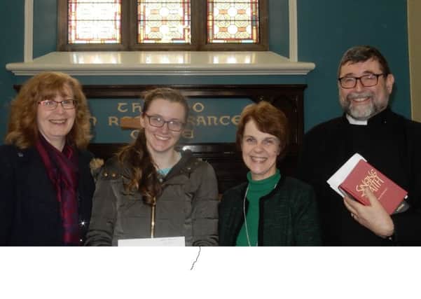 Nicola Wolfe, accompanied by her mother Alison, has received a cheque from Methodist Church lay leader Lynda Neilands and minister Rev. Chris Skillen.