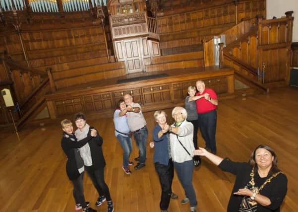 The Mayor of Derry City and Strabane District Council, Michaela Boyle pictured enlisting the help of some German tourists visiting the city to launch her new series of tea dances at the Main Hall, Guildhall on Wednesday morning.  Photo: Jim McCafferty Photography