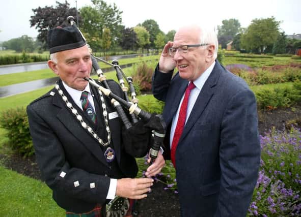 Winston Pinkerton, President of the Northern Ireland Branch of the Royal Scottish Pipe Band Association pipes a tune for Alderman Allan Ewart MBE, Chairman of the council's Development Committee at the launch of the Lisburn & Castlereagh Pipe Band Championships that will take place in Moira Demesne on Saturday 10th August.