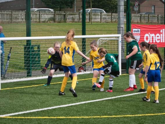 Derry City Ladies pull back a goal against Sion Swifts in the girls under-9 game at Caw on Monday.