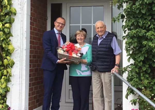 Reg and Eleanor Rendell of Cable Road in Whitehead are congratulated by Neil McCracken, general manager, Sales at Phoenix Natural Gas, on being the towns first customer to connect to the natural gas network as part of a major expansion project.