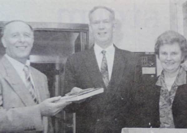 Manager of Carrick Adult Centre Bill McCormick receives equipment from Trevor Monteith, chair of the Parents' Association. Included is John McQuarry and Maureen Anderson. 1991