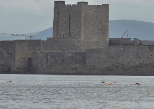 The swimmers practising for the challenge against the backdrop of Carrickfergus Castle