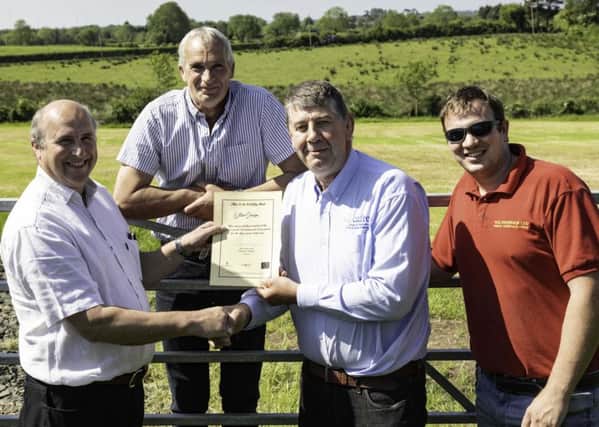 CAFRE Agricultural Business Operations (Level II) course manager Kenneth Johnston congratulates William Dennison from Antrim on achieving his Level 2 Agriculture Business Operations certificate. Looking on are Williams son James and his brother Stirling who also successfully completed the programme