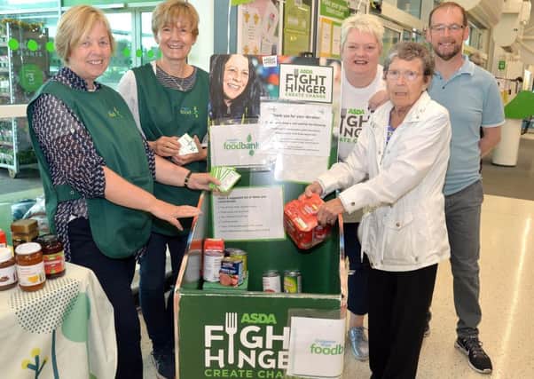 Pictured with the Craigavon area Foodbank donations trolley at Asda, Portadown, are from left, Angela Belshaw and Angela McVeigh, Craigavon Area Foodbank volunteers, Asda Community Champion, Elaine Livingstone, Philomena Dale, customer, (Portadown), and Martin Stevenson, Craigavon Area Foodbank manager.