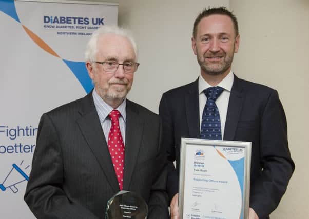 Tom Rush receives his Diabetes UK Inspire Award from Dr David Chaney.