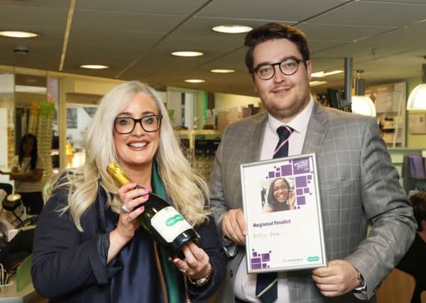 Specsavers Abbey Centre manager Darryl Marshall presents Michelle with her Spectacle Wearer of the Year prize.