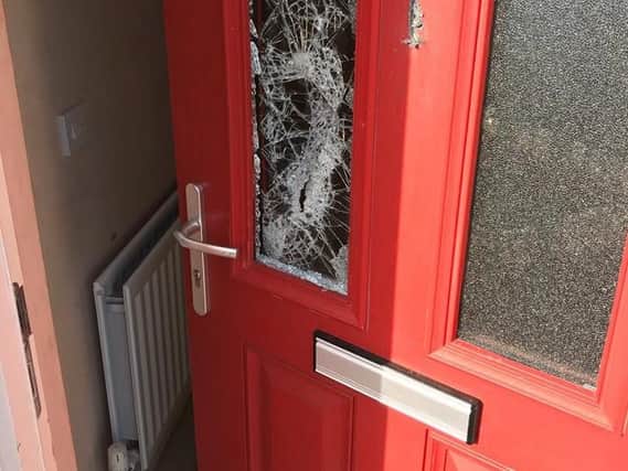 One of the doors damaged during the searches.
