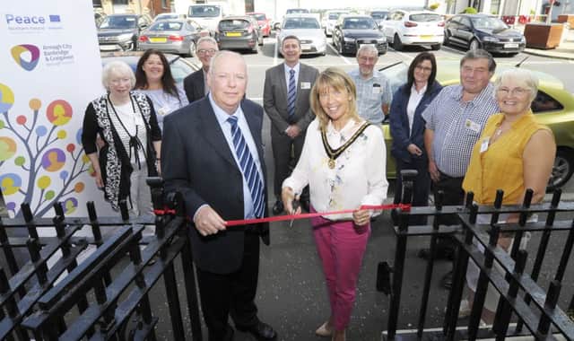 Deputy Lord Mayor for Armagh City, Banbridge and Craigavon Borough, Councillor Margaret Tinsley, is joined by Pat Rafferty Chair of Rathfriland and District Regeneration Company to cut the ribbon and officially open the new Community Hub and Sensory Room in Rathfriland