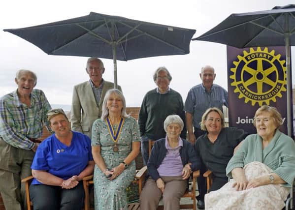 Rotarians Colin de Fleury, Jim Kelso, Colin McCarthy and Sam Crowe with (seated from left) Wendy Turkington, deputy manager, Knockagh Rise; Hilary McGavock, president of Carrickfergus Rotary Club; resident May McCracken,  Michaela Chambers, activity co-ordinator at the home and resident Niomi Bradshaw.