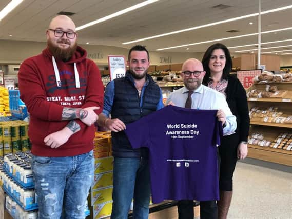 Tony Devin Store Manager of Newells Coalisland and Gary ONeill owner of V&S Bouncy Castles sponsors of the Niamh Louise Foundation walk & Talk event receiving an event T-shirt from Foundation Committee members Sam Benson and Fionuala Hughes.