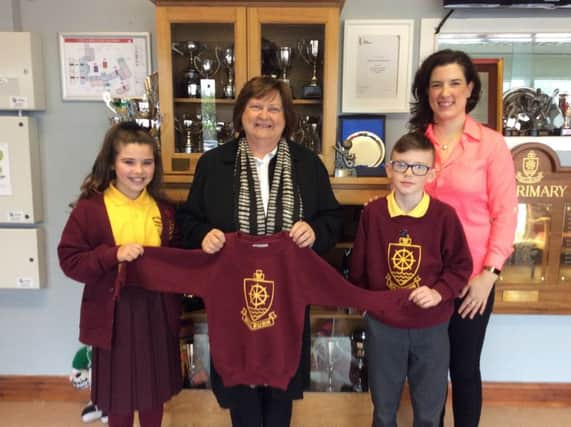 Pictured is Millburn Head Boy and Head Girl handing over school uniforms to Roisin McCaughan (ZAP), with teacher Ms Kathryn Robinson