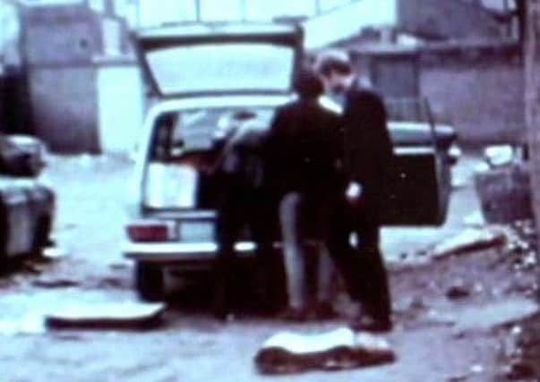 IRA men, one of whom is allegedly Martin McGuinness, load what appears to be components for an explosive device into a car in Derry in 1972. Photo: BBC NI Spotlight.