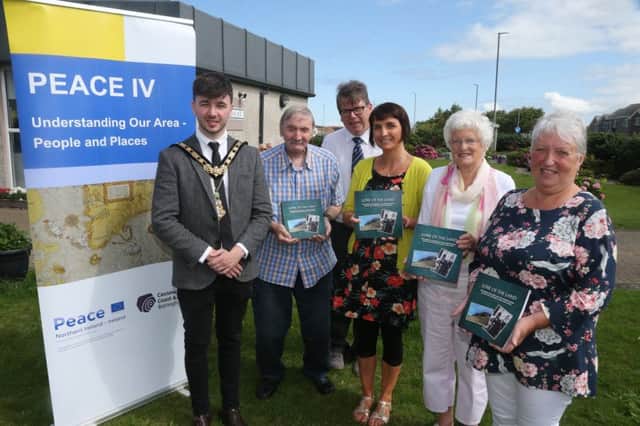 The Mayor of Causeway Coast and Glens Borough Council Councillor Sean Bateson pictured with some of the Clanmil Housing Association participants and Patricia Crossley, Vice Chair of the PEACE IV Partnership at the launch of the Lore of the Land book