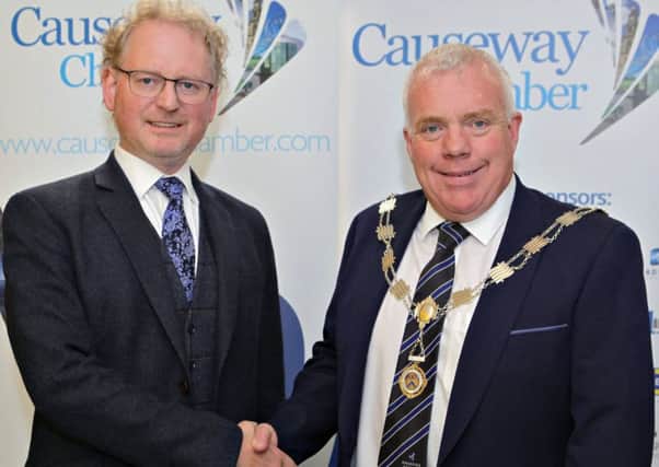 Outgoing President Murray Bell congratulates the new Causeway Chamber of Commerce President David Boyd on his appointment at the AGM held at the Enterprise Causeway offices