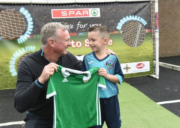 Riley Deans of the Greenisland 2011 team is presented with a Northern Ireland football shirt from team manager, Michael O'Neill after winning a penalty shootout in association with Ginster's, an official partner of the Irish FA at SPAR Fortfield's Customer Celebration event.