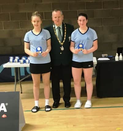 Pictured is Laura, on the right hand side with partner Sophia Noble from Leinster and William Martin, President of Ulster Badminton Association