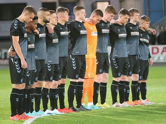 The Rangers players observe a minute's silence in memory of Fernando Ricksen