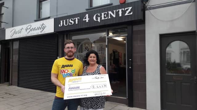 Michael Martin from Banbridge presenting Lesley Wright from AWARE with a cheque following his recent walk