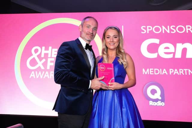 NI Health and Fitness Awards Judge Ian Young presents winner of Female Personal Trainer of the Year Rachel McCartan with her Trophy