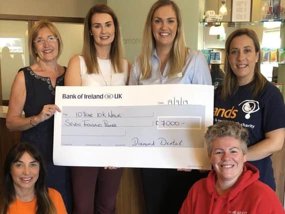 Staff at Diamond Dental Clinic raised 7,000 for five charities 'close to their hearts'. Members of staff are pictured with representatives of the charities.