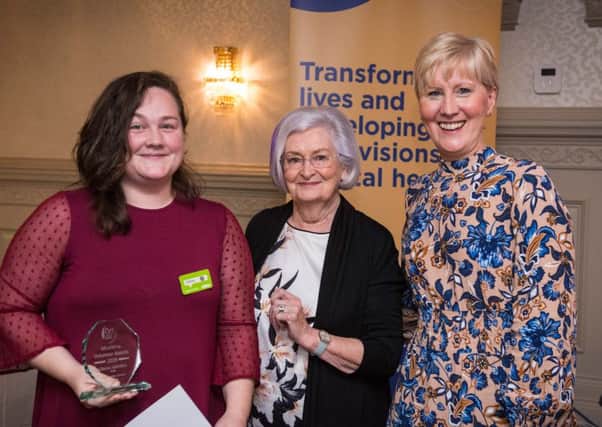 Claione Alderdice, ASDA Ballyclare Community Champion, receiving the Community Partner Award from Patsy England, a founder of the National Schizophrenia Fellowship and Jayne Wright, HR Director for MindWise.