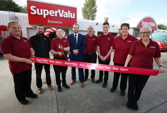 SuperValu Lisburn's Eddie Sharkey cutting the ribbon alongside store manager Jamie Graham (centre) and members of the team