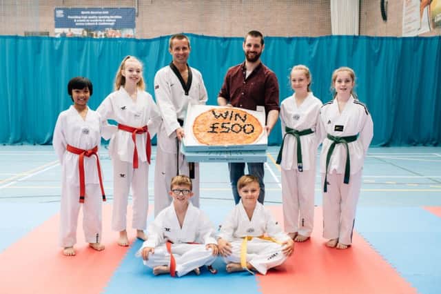 Peter Stewart, coach and Philip Pettitt, general manager, Little Wing Little Stars, pictured with members of the Taekwondo club, one of last years winning clubs