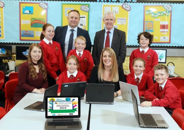 Primary 6 and 7 digital leaders from Ballyclare Primary with teachers Mrs Sarah Scott and Mrs Karen Irwin (cent. Also pictured are Pete Murphy from RM Education and Dr Victor McNair Digital Schools Validator.