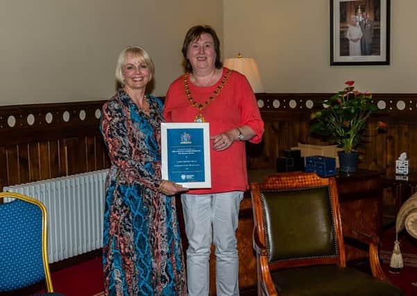 Mayor Maureen Morrow presents a certificate to Larne Drama Circle Vice-Chairman Lorna Ringland in recognition of 70 years of the Circle.
(PICTURES KINDLY SUBMITTED)
