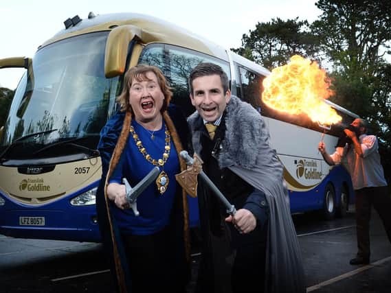 Mayor of Mid and East Antrim, Councillor Maureen Morrow, pictured with John Morgan from Translink and fire performer Logy.