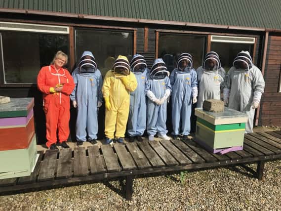 A few members of the Beekeeping Club in their protective suits and their recent awards