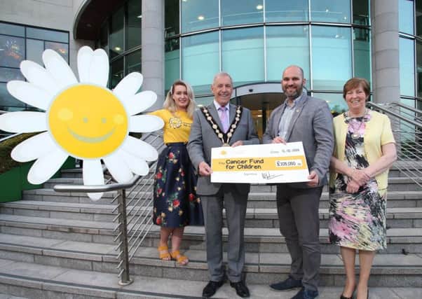 Former Mayor and Mayoress of Lisburn & Castlereagh City Council, Councillor Uel Mackin and Jennifer Mackin present a cheque for £105,050 to Phil Alexander, CEO and Sarah Clements from Cancer Fund for Children.  This money was raised by Councillor Mackin during his mayoral term.