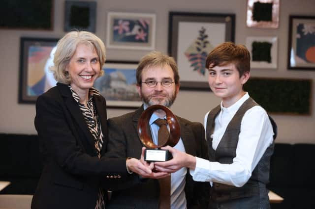 Dr Mark McCartney with his wife Karen and younger son Peter after receiving the Maths Week Ireland 2019 award for Raising Public Awareness of Maths.