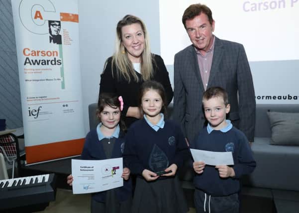 Children from Carhill Integrated Primary School with principal, Samantha
Russell, receive their Carson Prize from Tony Carson at a ceremony at the Ormeau Baths, Belfast